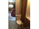 The bathroom with a toilet and a view to the kitchen at 108 Captains Ct # B116, Mount Gilead, NC 27306