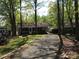 Charming single-story home with gravel driveway surrounded by mature trees at 108 Captains Ct # B116, Mount Gilead, NC 27306