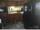 The kitchen features wood cabinets, laminate flooring, and black appliances at 108 Captains Ct # B116, Mount Gilead, NC 27306