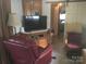 Cozy living area with a TV, comfortable seating, and an open view to the bathroom at 108 Captains Ct # B116, Mount Gilead, NC 27306