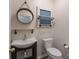 Half bathroom featuring modern fixtures, a circular mirror, and decorative wall accents at 1144 Spicewood Pines Rd, Fort Mill, SC 29708