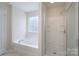 Bright bathroom featuring a bathtub, a separate glass-door shower, and a window for natural light at 1144 Spicewood Pines Rd, Fort Mill, SC 29708