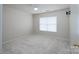 Bright bedroom featuring plush carpeting, a ceiling fan, a window for natural light, and a wall-mounted TV bracket at 1144 Spicewood Pines Rd, Fort Mill, SC 29708