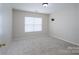 Neutral bedroom featuring plush carpeting, a window for natural light, and a wall-mounted TV bracket at 1144 Spicewood Pines Rd, Fort Mill, SC 29708
