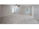 Spacious bedroom with neutral carpet, ceiling fan and three windows offering lots of natural light at 1144 Spicewood Pines Rd, Fort Mill, SC 29708