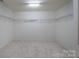 Spacious walk-in closet featuring installed shelving and neutral carpet at 1144 Spicewood Pines Rd, Fort Mill, SC 29708