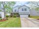 Charming two-story home with a well-manicured lawn, two car garage, and tasteful landscaping at 1144 Spicewood Pines Rd, Fort Mill, SC 29708