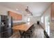 Spacious kitchen featuring an island with seating, stainless steel refrigerator, and modern lighting fixture at 1144 Spicewood Pines Rd, Fort Mill, SC 29708