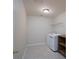 Functional laundry room with washer, dryer, shelving, and tiled flooring at 1144 Spicewood Pines Rd, Fort Mill, SC 29708