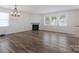 Open living room with a fireplace and elegant dark hardwood floors at 1144 Spicewood Pines Rd, Fort Mill, SC 29708