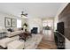 Inviting living room featuring a ceiling fan, hardwood floors, and an open floor plan leading to the dining area at 1144 Spicewood Pines Rd, Fort Mill, SC 29708