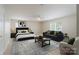 Stylish living room setup with modern furniture, a cozy bed, and ample natural light from a window at 1144 Spicewood Pines Rd, Fort Mill, SC 29708