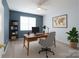 Office space featuring a desk, bookcase, neutral carpet, ceiling fan, and a window with natural light at 1144 Spicewood Pines Rd, Fort Mill, SC 29708
