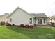 Charming home exterior with a patio and flower beds, creating lovely curb appeal at 11623 Black Maple Ave, Charlotte, NC 28269