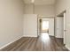 Bedroom featuring laminate floors, high ceilings, fan, and entrance to the bathroom at 11623 Black Maple Ave, Charlotte, NC 28269