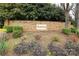 Stone community sign surrounded by colorful landscaping enhances neighborhood charm at 11623 Black Maple Ave, Charlotte, NC 28269