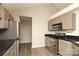 Bright kitchen with stainless steel appliances, light grey cabinets, and black countertops at 11623 Black Maple Ave, Charlotte, NC 28269