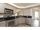 Charming kitchen with stainless appliances, black countertops, and open view to the living room at 11623 Black Maple Ave, Charlotte, NC 28269