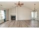 Spacious living room featuring vaulted ceilings, a modern fireplace, and natural light from multiple windows at 11623 Black Maple Ave, Charlotte, NC 28269