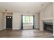 Bright and airy living room featuring a modern fireplace, wood floors, and natural light from large windows at 11623 Black Maple Ave, Charlotte, NC 28269