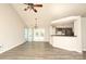 Open-concept living area featuring a modern fireplace, vaulted ceilings, and easy access to the adjacent kitchen at 11623 Black Maple Ave, Charlotte, NC 28269