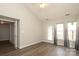 Living room with laminate floors, high ceilings, fan, door, and natural light at 11623 Black Maple Ave, Charlotte, NC 28269