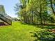 Expansive backyard with stairs leading to a deck, showcasing the property's outdoor living space at 11778 Crossroads Pl, Concord, NC 28025