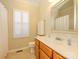Well-lit bathroom with a white vanity, framed mirror, and a shower with a curtain at 11778 Crossroads Pl, Concord, NC 28025