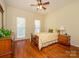 Bright bedroom with hardwood floors, a ceiling fan, and natural lighting at 11778 Crossroads Pl, Concord, NC 28025