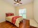 Comfortable bedroom with hardwood floors, ceiling fan, and natural light from the window at 11778 Crossroads Pl, Concord, NC 28025