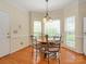 Charming breakfast nook with sunlit windows, round table, and seating for four at 11778 Crossroads Pl, Concord, NC 28025
