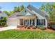 Charming home with rocking chairs on the porch and a manicured lawn at 11778 Crossroads Pl, Concord, NC 28025