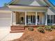 Inviting covered porch with rocking chairs and brick steps at 11778 Crossroads Pl, Concord, NC 28025