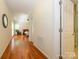 Long hallway with views to a furnished bedroom and bathroom with glass enclosed shower at 11778 Crossroads Pl, Concord, NC 28025