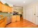 Bright kitchen features hardwood floors, stainless steel appliances, granite counters, and ample cabinet space at 11778 Crossroads Pl, Concord, NC 28025