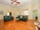 Open living space with hardwood floors and views to foyer and kitchen at 11778 Crossroads Pl, Concord, NC 28025