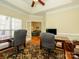 Spacious office featuring a tray ceiling, a ceiling fan, and views into the Gathering room at 11778 Crossroads Pl, Concord, NC 28025