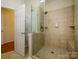 Walk-in shower with tiled walls and a glass enclosure at 11778 Crossroads Pl, Concord, NC 28025