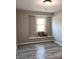 Bedroom with a built-in bench and large window at 11817 Five Cedars Rd, Charlotte, NC 28226