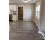 Dining area featuring wood-look flooring, a window, and a view into the kitchen at 11817 Five Cedars Rd, Charlotte, NC 28226