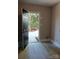Bright entryway featuring a black door, neutral walls, and wood-look flooring with an open view to the outdoors at 11817 Five Cedars Rd, Charlotte, NC 28226