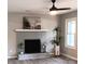 Living room featuring a painted fireplace with decorative accents and wood-look floors at 11817 Five Cedars Rd, Charlotte, NC 28226