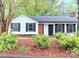 Charming single-story home with black shutters, a black door, and brick accents at 11817 Five Cedars Rd, Charlotte, NC 28226