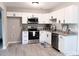 Bright kitchen featuring white cabinets, stainless steel appliances, and granite countertops at 11817 Five Cedars Rd, Charlotte, NC 28226