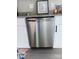 Close-up of a stainless steel dishwasher and surrounding white cabinets with dark hardware at 11817 Five Cedars Rd, Charlotte, NC 28226