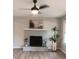 Bright living room features a decorative fireplace, ceiling fan and neutral tones at 11817 Five Cedars Rd, Charlotte, NC 28226