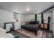 Modern bedroom with an industrial ceiling, two bright windows, and stylish furnishings and decor at 119 Meadowbrook Ln, Davidson, NC 28036