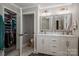 Well-lit bathroom featuring a double sink vanity, and an accessible closet at 119 Meadowbrook Ln, Davidson, NC 28036