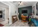 Bedroom with desk, TV, decor, and golf clubs under a ceiling fan, next to an open doorway at 119 Meadowbrook Ln, Davidson, NC 28036