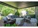 Inviting covered patio with comfortable seating, perfect for outdoor relaxation and entertaining at 119 Meadowbrook Ln, Davidson, NC 28036